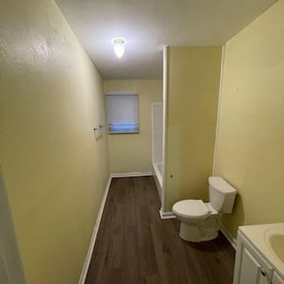 bathroom with vanity, toilet, and hardwood / wood-style flooring