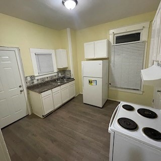 kitchen featuring sink, hardwood / wood-style flooring, white fridge, white cabinets, and stove