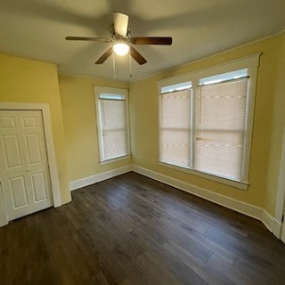 spare room with ceiling fan, crown molding, and dark hardwood / wood-style floors