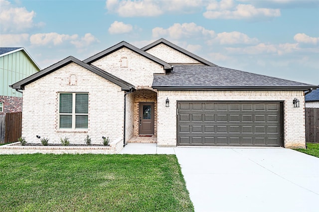 view of front of house featuring a front yard and a garage