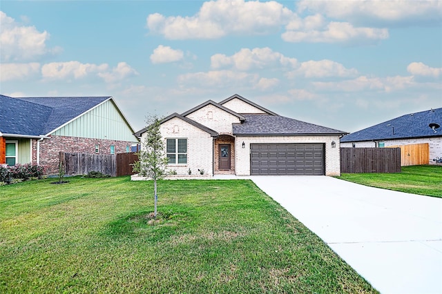 view of front of home with a garage and a front lawn