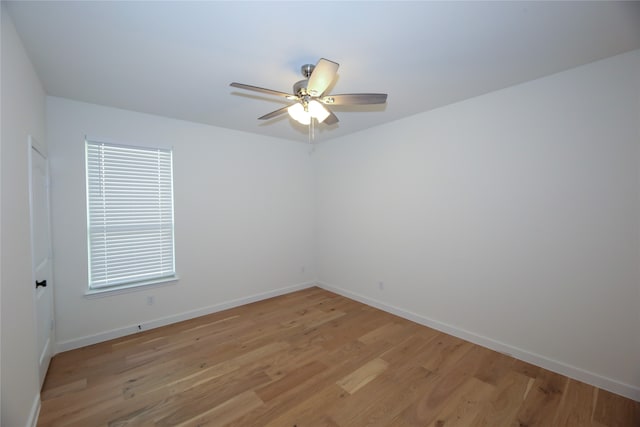 spare room featuring light hardwood / wood-style flooring, ceiling fan, and a healthy amount of sunlight