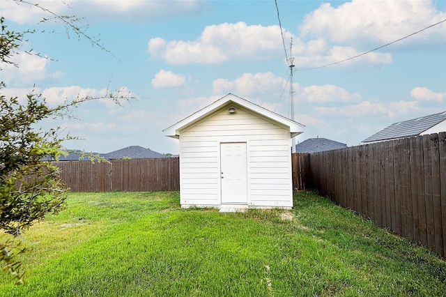 view of outbuilding featuring a yard