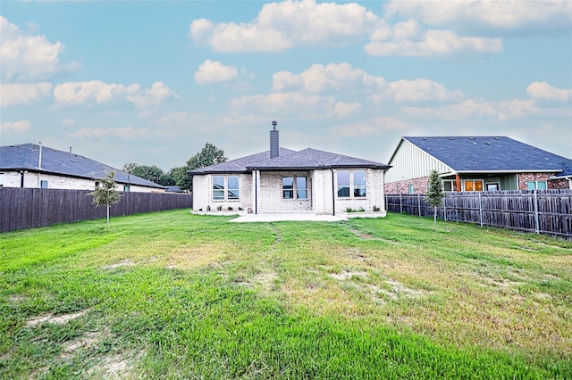 back of property featuring a patio area and a yard