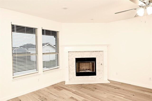 details with a premium fireplace, wood-type flooring, and ceiling fan