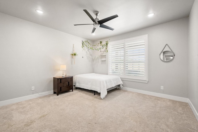 bedroom featuring baseboards, recessed lighting, a ceiling fan, and light colored carpet