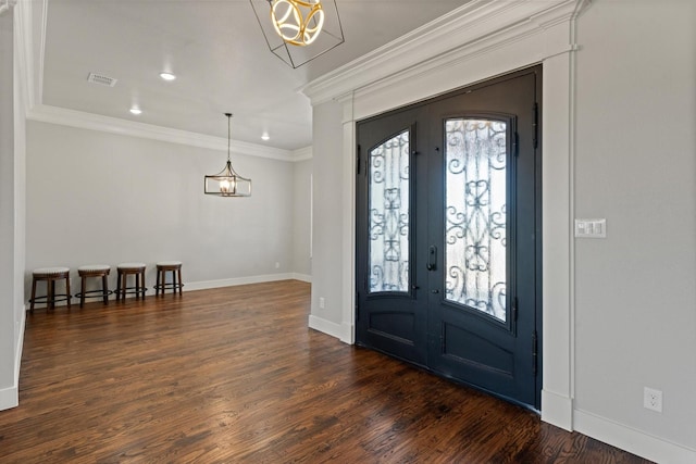 foyer with french doors, dark wood-style flooring, plenty of natural light, and visible vents