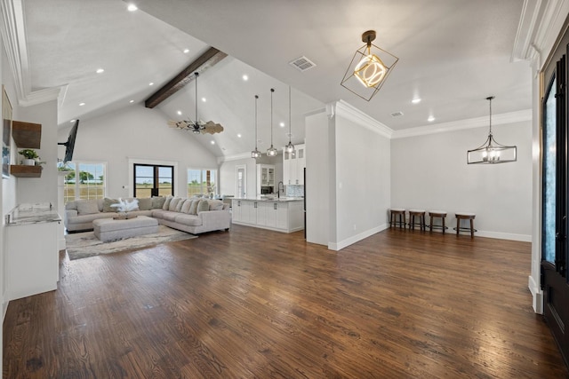 living area featuring an inviting chandelier, visible vents, dark wood-type flooring, and beamed ceiling