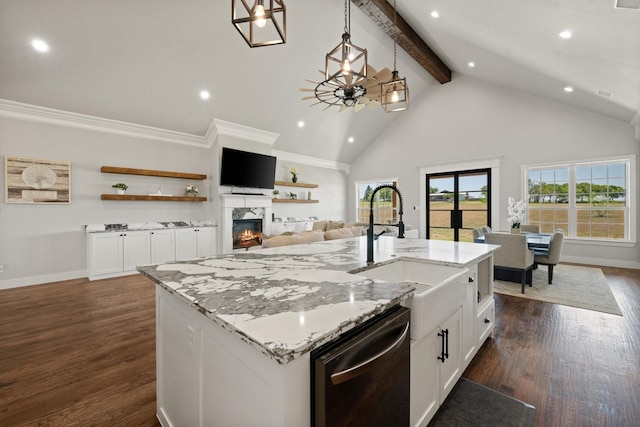 kitchen with dishwashing machine, hanging light fixtures, a kitchen island with sink, white cabinetry, and a sink