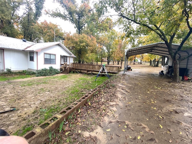 view of yard with a carport and a deck