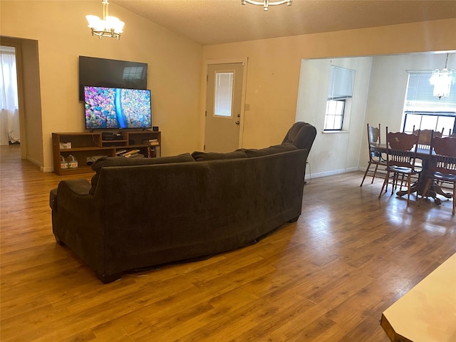 living room featuring hardwood / wood-style flooring and an inviting chandelier