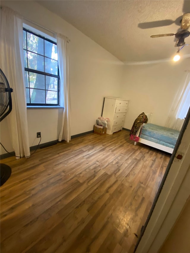 unfurnished bedroom featuring ceiling fan and hardwood / wood-style flooring