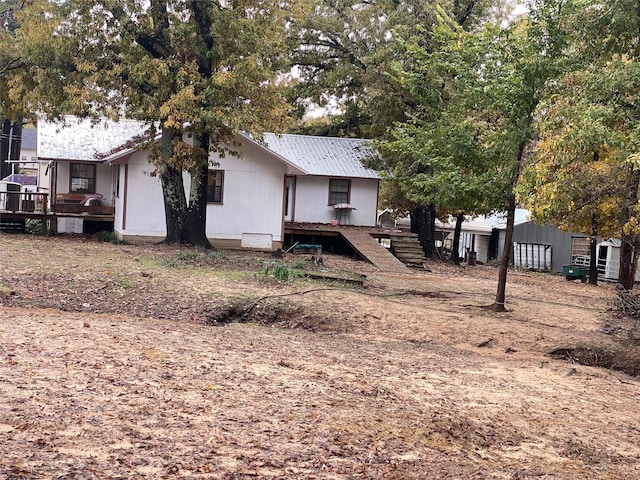 back of property featuring a deck