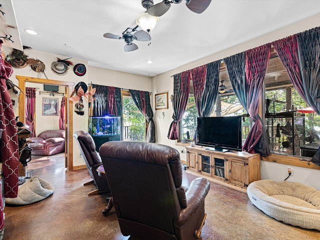 living room featuring ceiling fan and a wealth of natural light