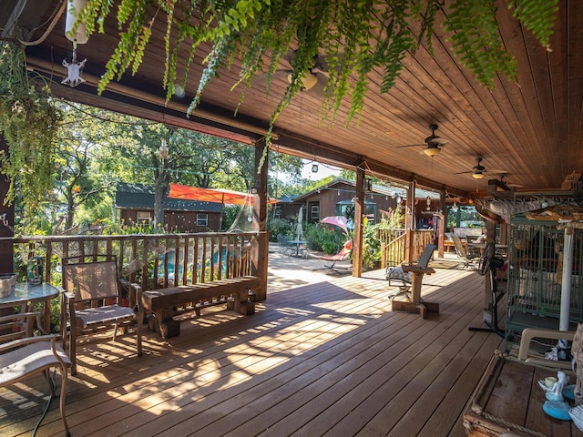 wooden terrace featuring ceiling fan