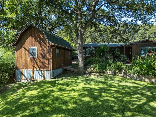 view of side of home with a yard