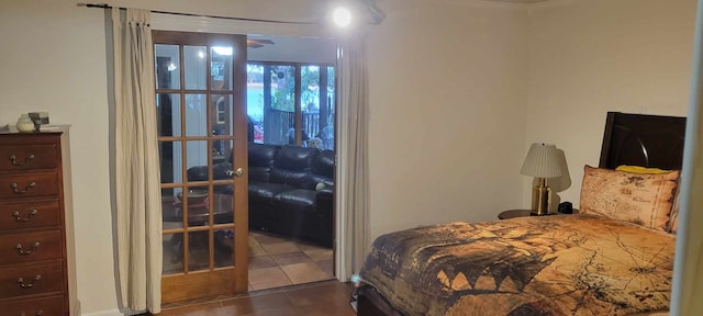 tiled bedroom featuring french doors