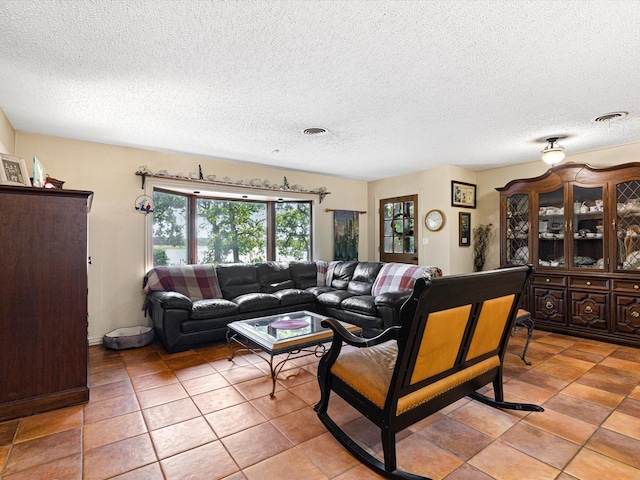 living room with light tile patterned floors and a textured ceiling