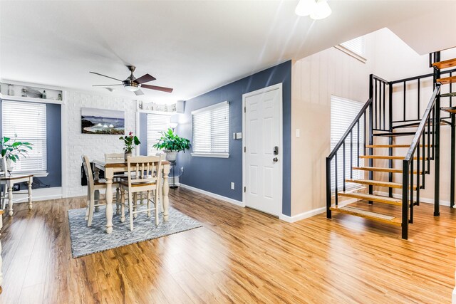 dining room with ceiling fan and hardwood / wood-style flooring