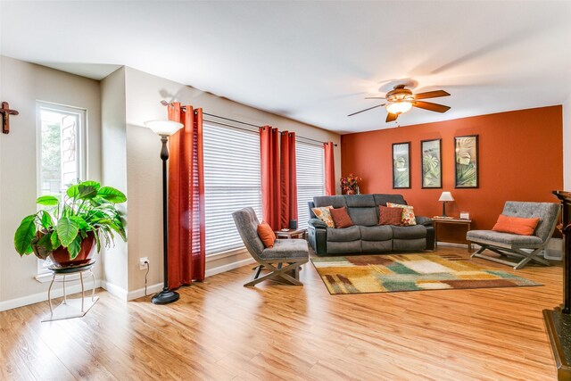 living room featuring ceiling fan and light hardwood / wood-style floors