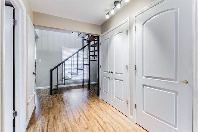 foyer with track lighting and hardwood / wood-style flooring