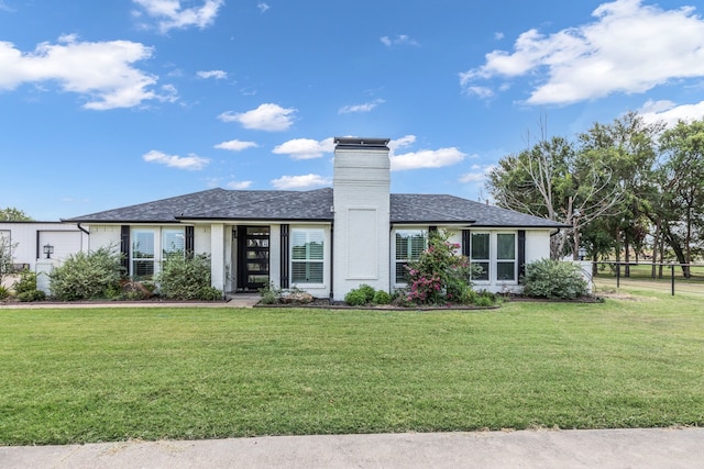 ranch-style home featuring a front yard