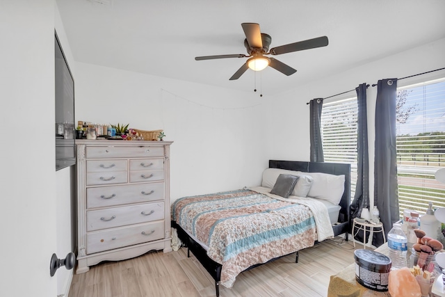 bedroom with ceiling fan and light hardwood / wood-style floors