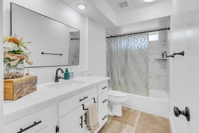 full bathroom featuring hardwood / wood-style floors, shower / tub combo, vanity, and toilet