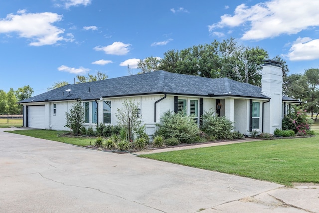 ranch-style house with a front lawn and a garage