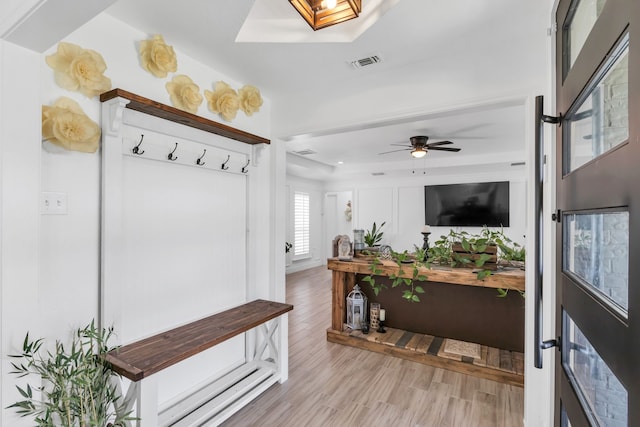 mudroom featuring ceiling fan, a skylight, and hardwood / wood-style flooring