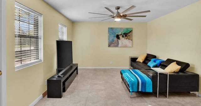 living room with light tile patterned flooring, plenty of natural light, and ceiling fan