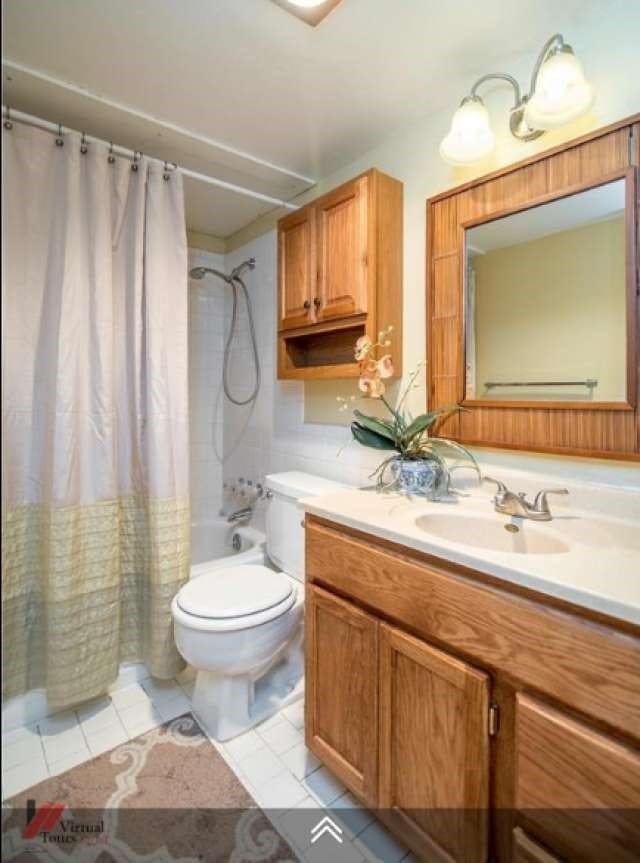 full bathroom featuring vanity, toilet, shower / bath combination with curtain, and tile patterned flooring