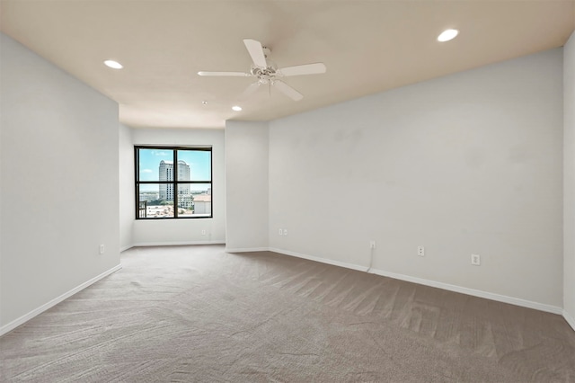 empty room featuring ceiling fan and carpet flooring