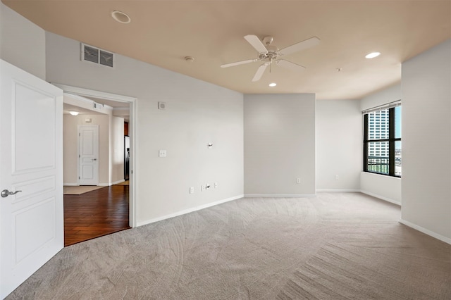 unfurnished room featuring ceiling fan and carpet flooring