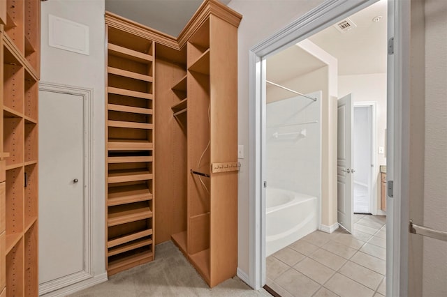 spacious closet with light tile patterned floors