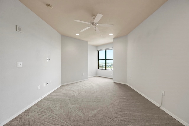 carpeted empty room featuring ceiling fan