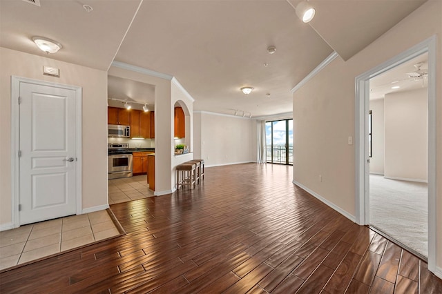 carpeted spare room with ceiling fan and crown molding