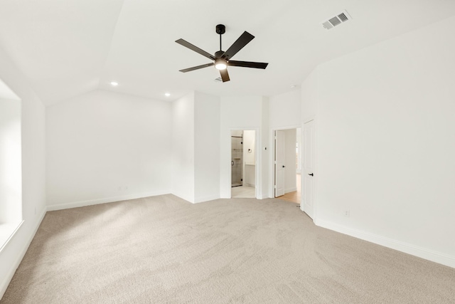 carpeted spare room with vaulted ceiling and ceiling fan