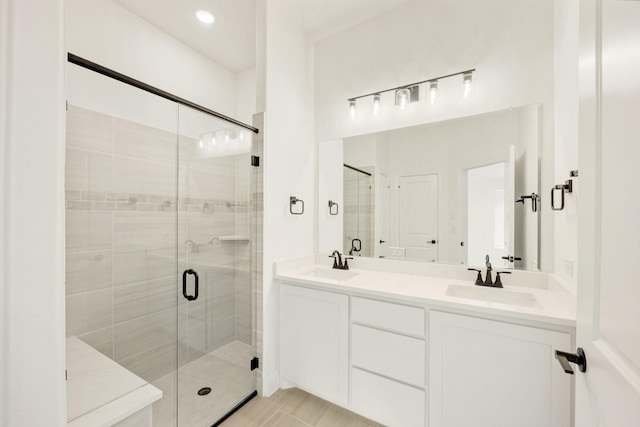 bathroom featuring vanity and an enclosed shower