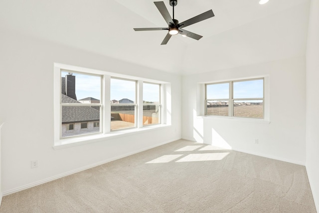 carpeted spare room featuring lofted ceiling and ceiling fan