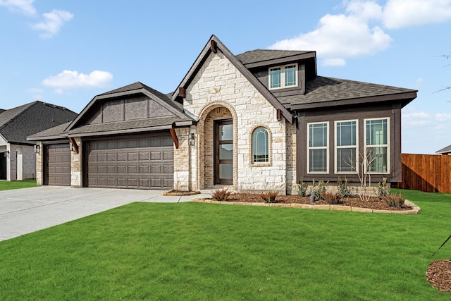 view of front of property featuring a front yard and a garage