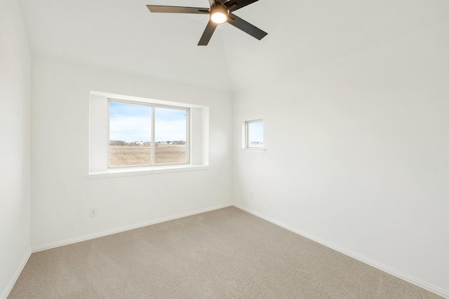 carpeted spare room with vaulted ceiling and ceiling fan