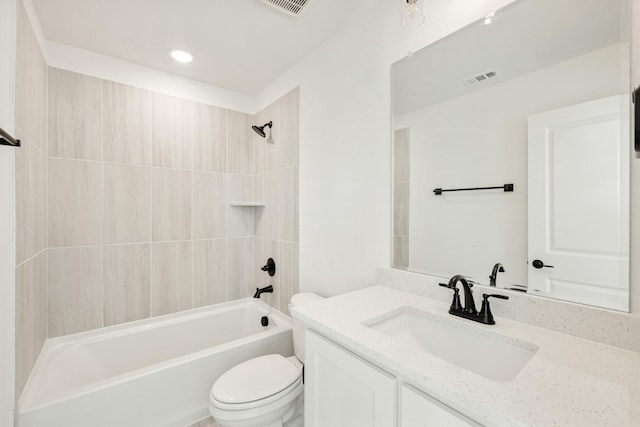 full bathroom with tiled shower / bath combo, vanity, and toilet