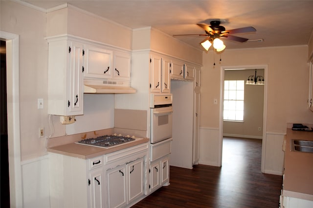 kitchen with white oven, white cabinetry, stainless steel gas stovetop, ceiling fan, and dark hardwood / wood-style floors