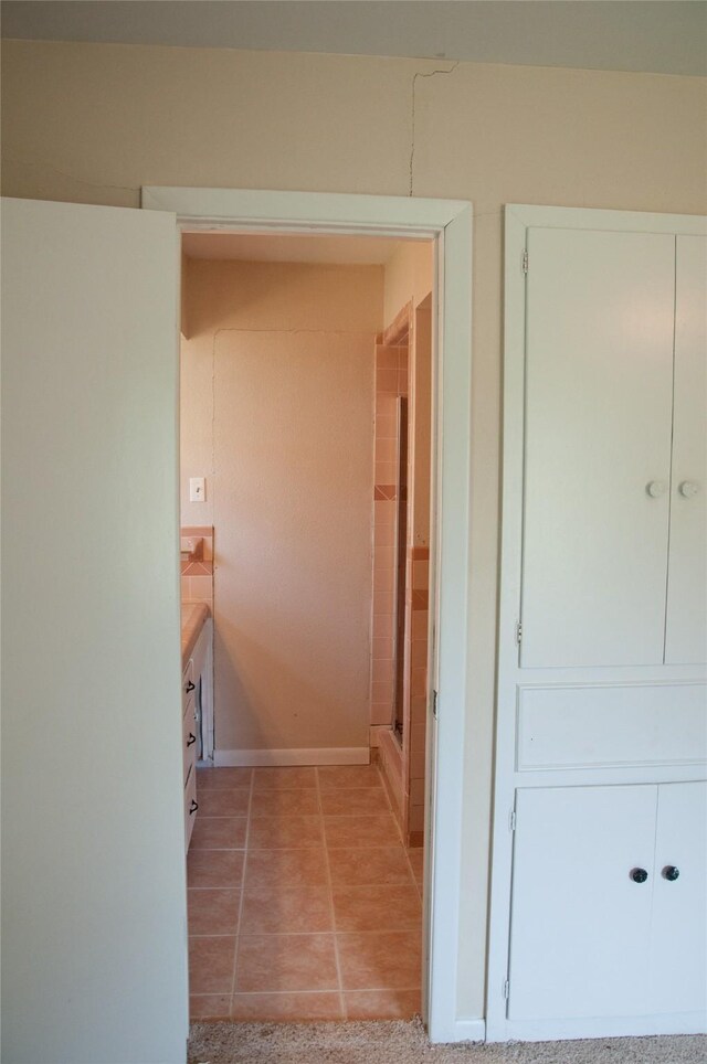 corridor featuring light tile patterned floors