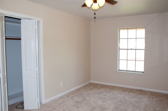 unfurnished bedroom featuring a closet, ceiling fan, light carpet, and multiple windows