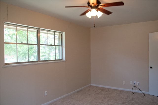 unfurnished room featuring ceiling fan and carpet flooring