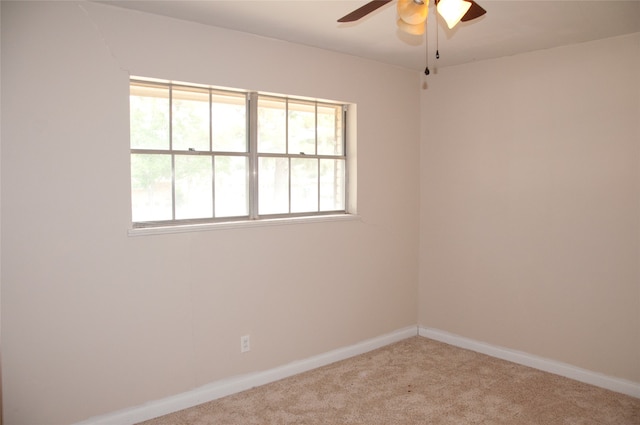 carpeted spare room with ceiling fan