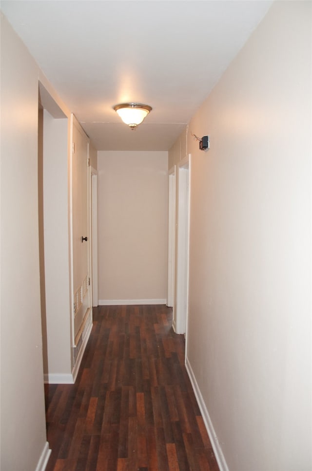 hallway with dark hardwood / wood-style flooring