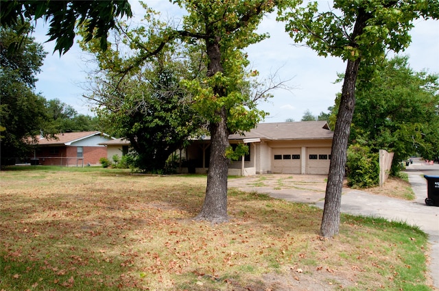 view of front of house with a garage and a front yard